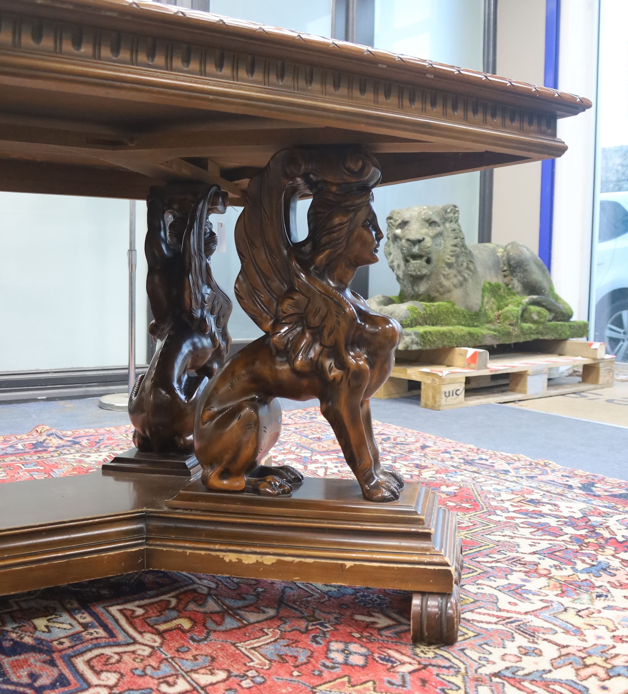 An Italian design rectangular walnut centre table with winged sphinx supports, width 196cm, depth 96cm, height 77cm